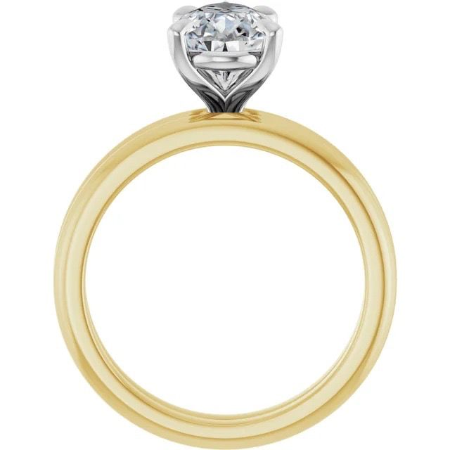 Profile view of a yellow gold solitaire engagement ring with a raised silver-tone prong setting