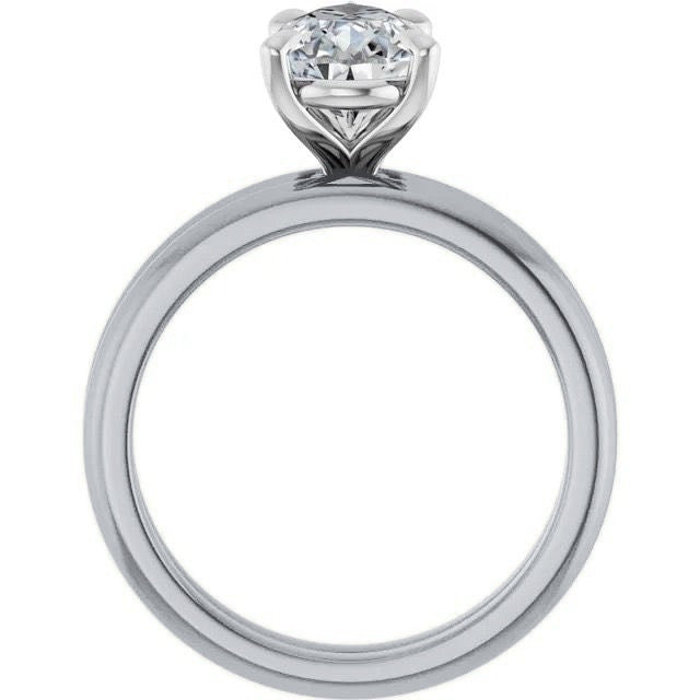 Profile view of a platinum solitaire engagement ring with a raised prong setting