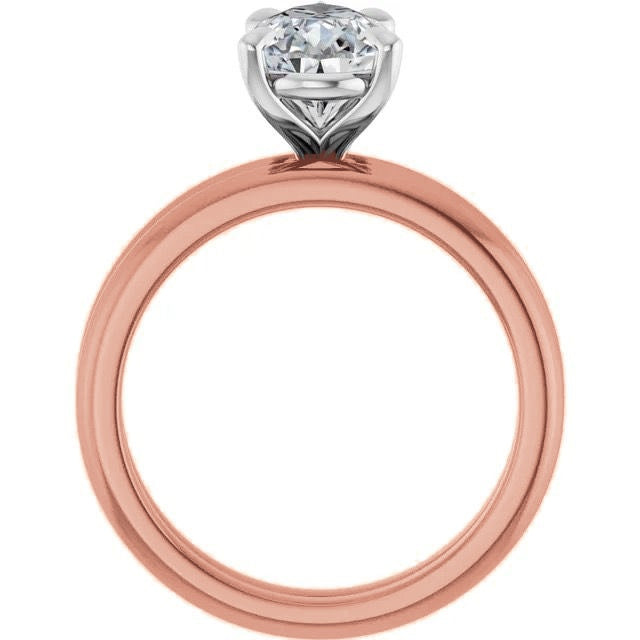 Profile view of a rose gold solitaire engagement ring with a raised silver-tone prong setting